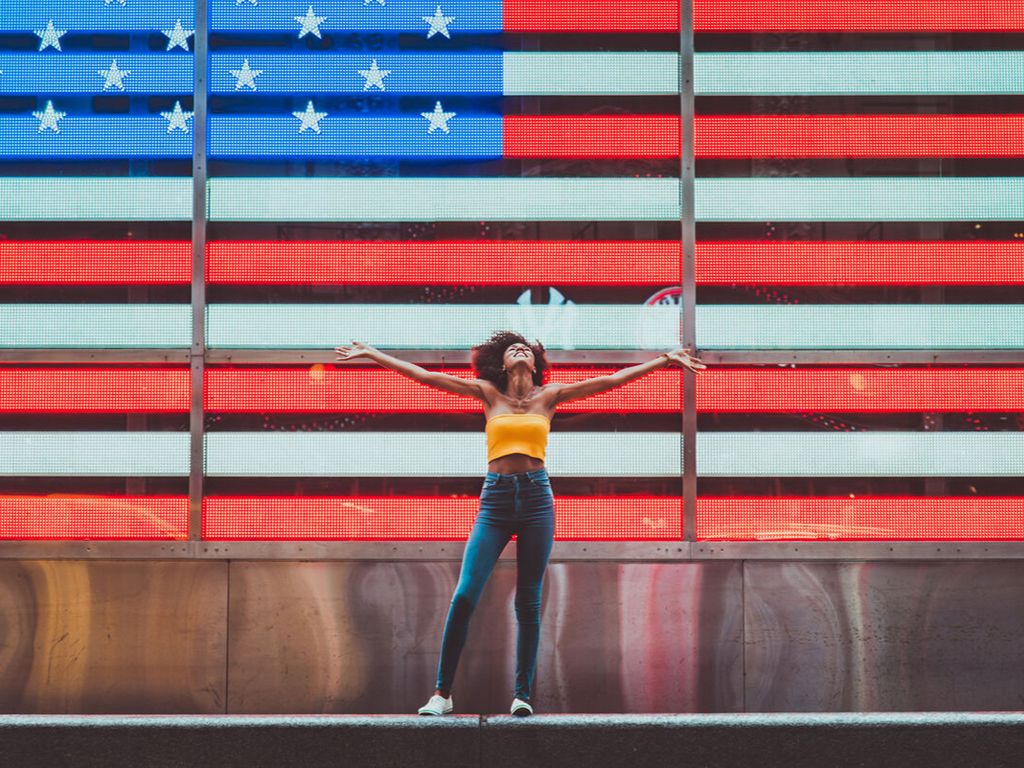 Lady in front of the USA flag